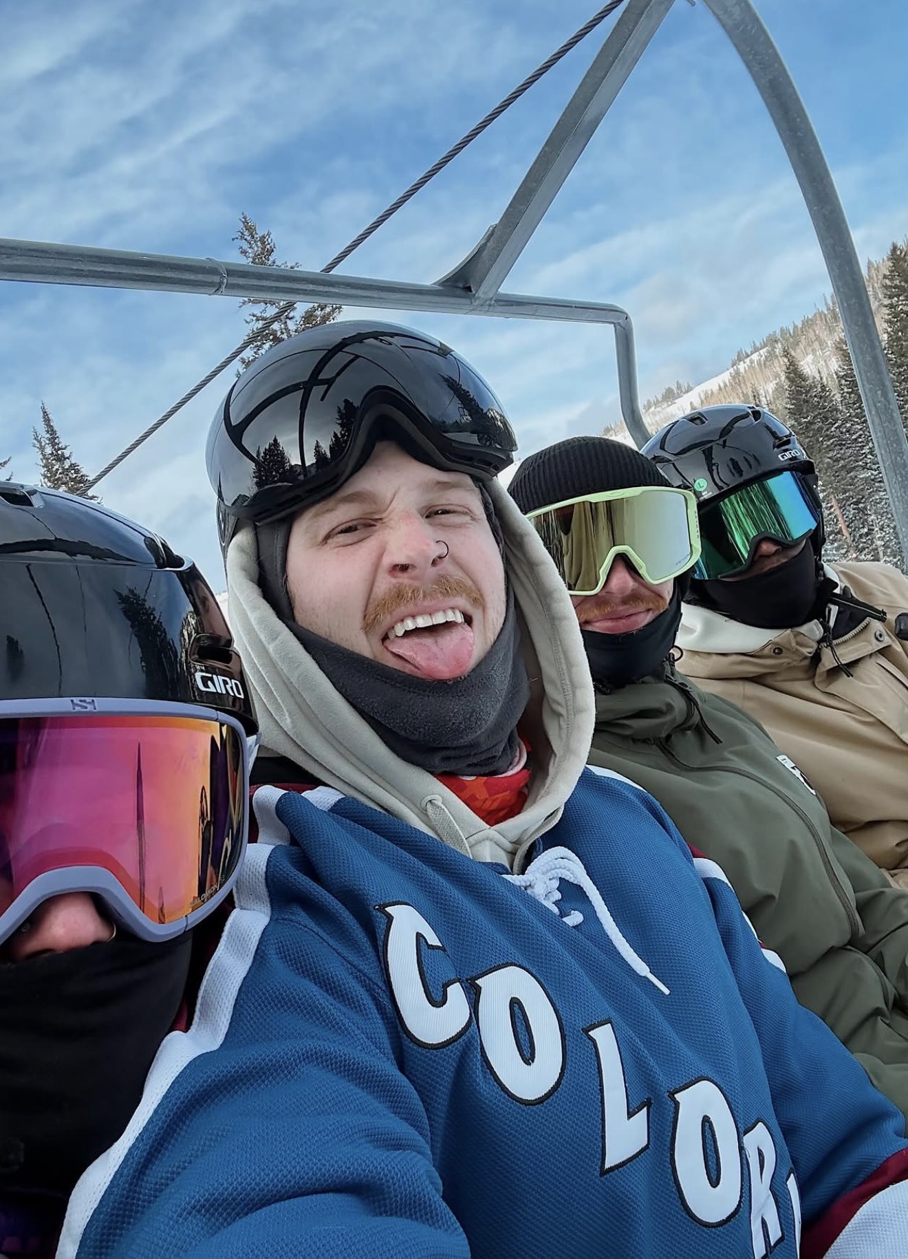 Team members taking a selfie on a chairlift during the Utah snowboarding trip