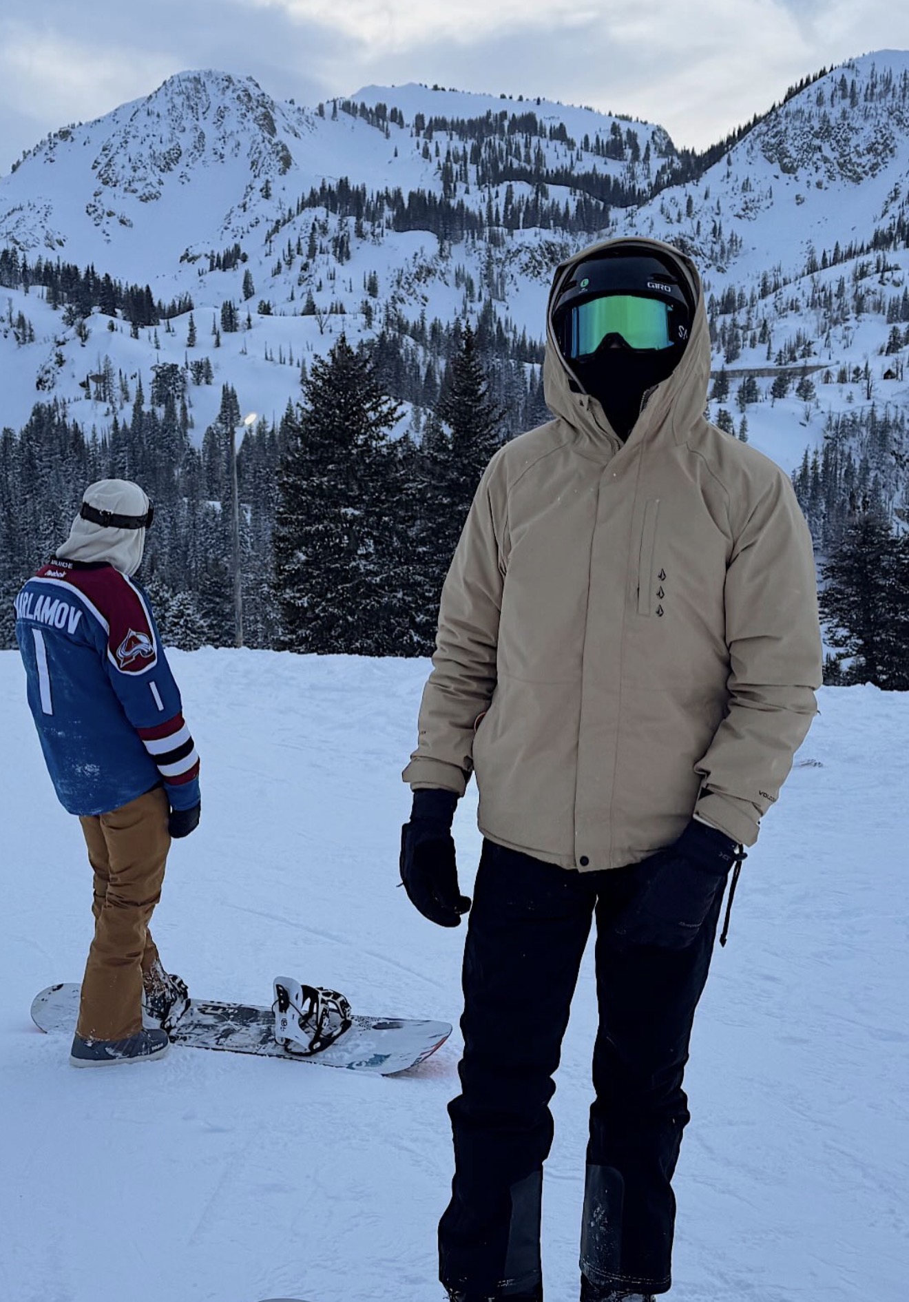 Team members with snowboards on a snowy mountain in Utah